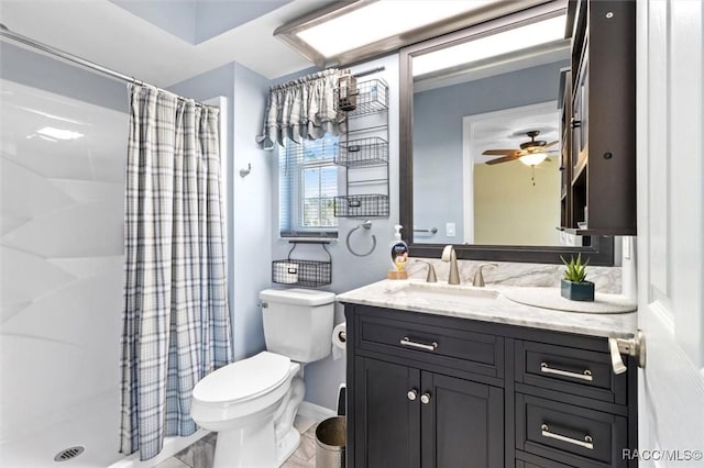 bathroom featuring vanity, ceiling fan, a shower with curtain, and toilet