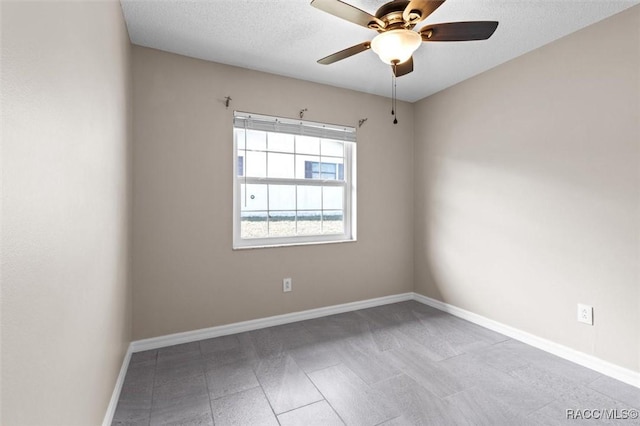 spare room featuring ceiling fan and a textured ceiling