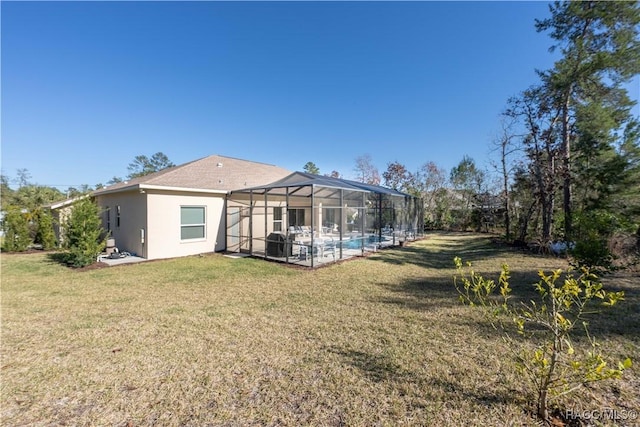 back of house featuring a lanai, an outdoor pool, a lawn, and stucco siding