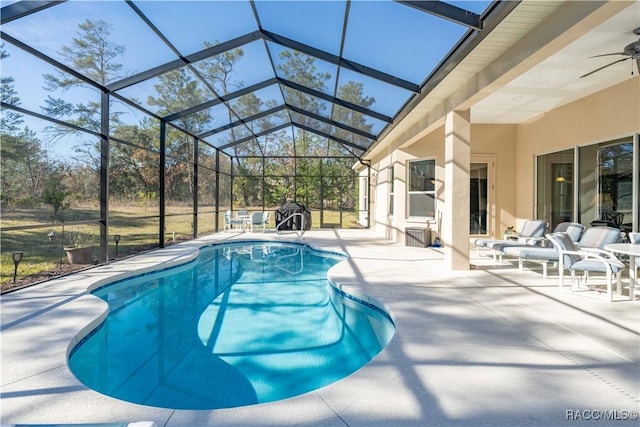 pool featuring a ceiling fan, a lanai, and a patio area