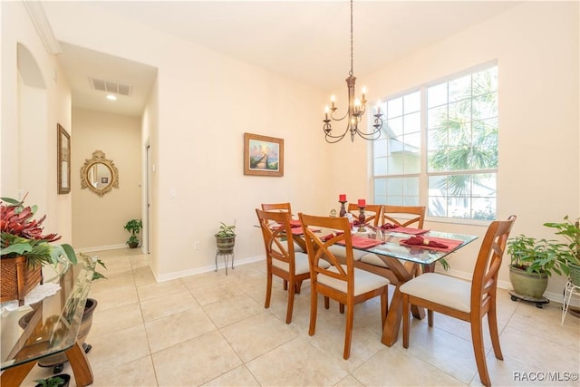 dining space with light tile patterned floors, baseboards, visible vents, and a chandelier