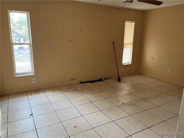 empty room with light tile patterned floors and ceiling fan