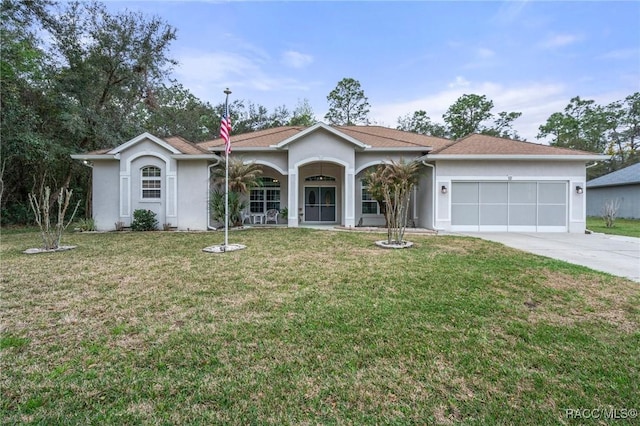 ranch-style house with a garage, concrete driveway, a front lawn, and stucco siding