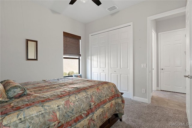 carpeted bedroom with ceiling fan and a closet