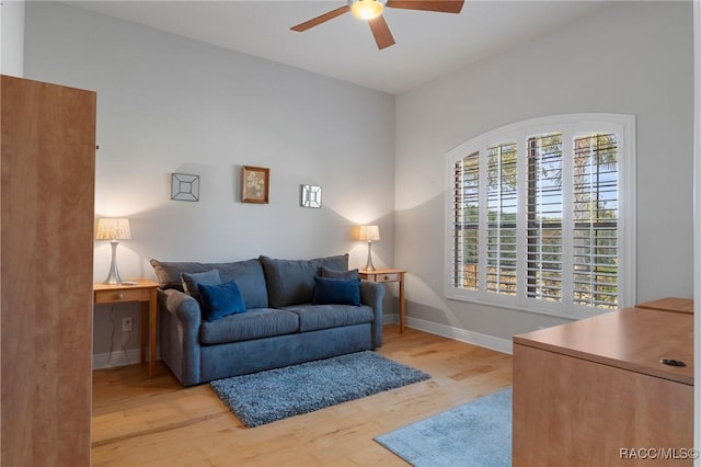 living room with light hardwood / wood-style floors and ceiling fan