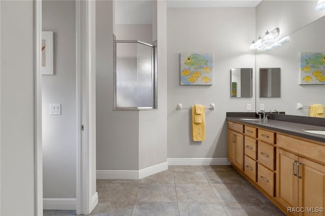 bathroom with vanity, an enclosed shower, and tile patterned floors