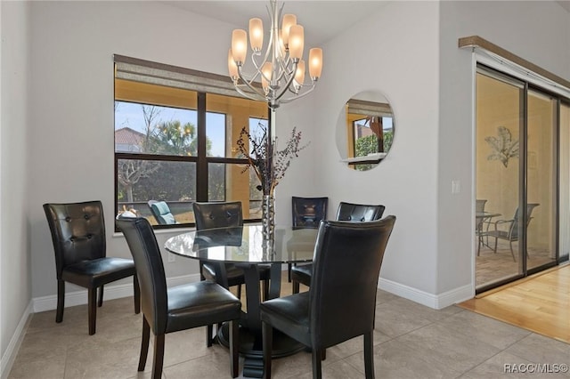 dining area with a chandelier and light tile patterned flooring