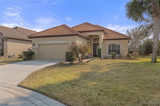 mediterranean / spanish house featuring a garage and a front yard