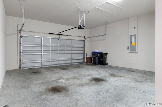 garage with a garage door opener and electric panel