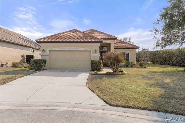 mediterranean / spanish-style house with a garage and a front yard