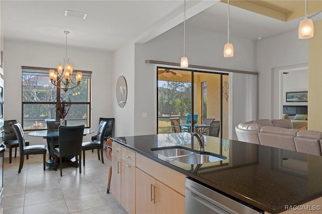 kitchen with light brown cabinetry, sink, pendant lighting, and dishwasher