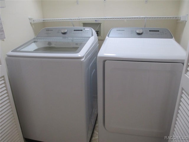 washroom with independent washer and dryer