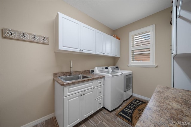 laundry area with sink, washer and clothes dryer, and cabinets