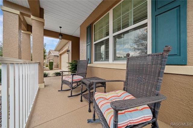 view of patio featuring a garage and covered porch