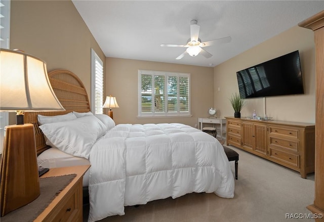 bedroom featuring light carpet and ceiling fan