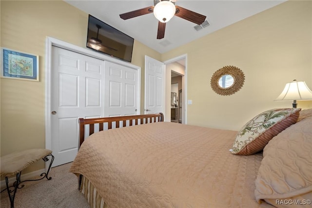 bedroom featuring a closet, ceiling fan, and carpet flooring