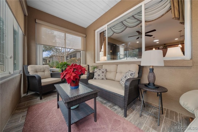 sunroom / solarium featuring ceiling fan