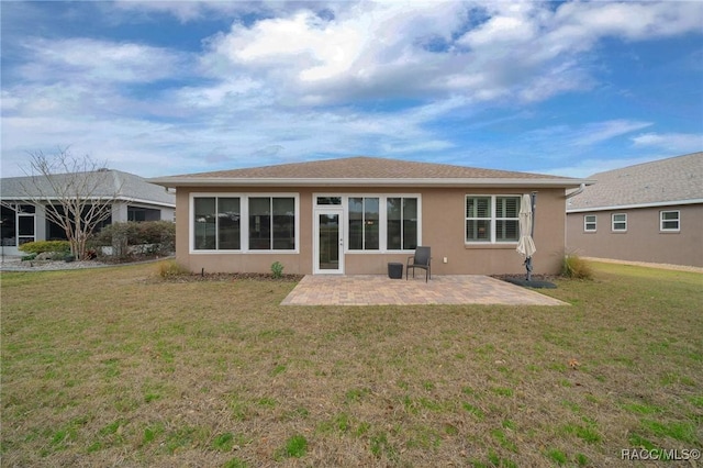 rear view of house with a patio area and a lawn