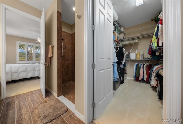 spacious closet with ceiling fan