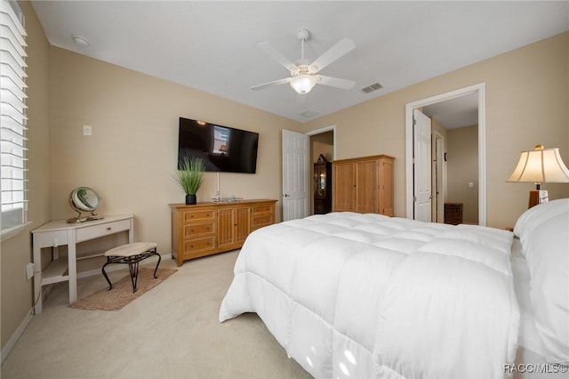 bedroom with light carpet and ceiling fan