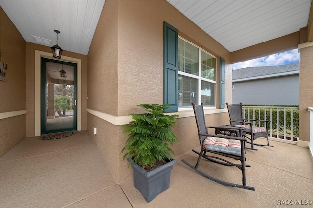 entrance to property featuring covered porch