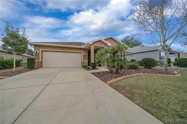 single story home featuring a garage and a front lawn