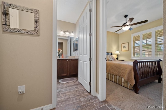 bedroom featuring sink, ensuite bath, and ceiling fan