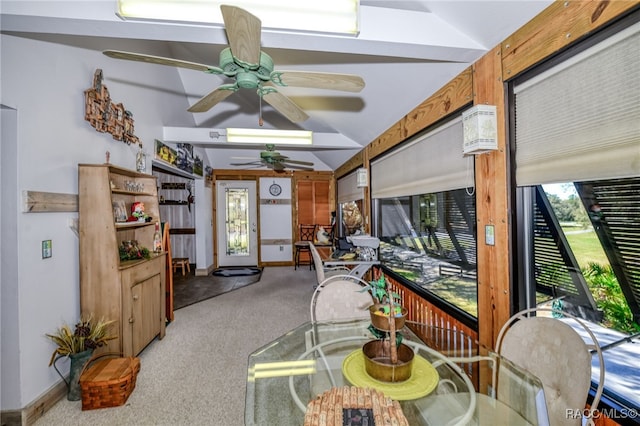 living area featuring carpet, a ceiling fan, a sunroom, vaulted ceiling, and baseboards