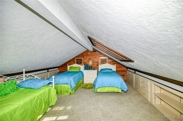 bedroom with lofted ceiling, a textured ceiling, and carpet flooring