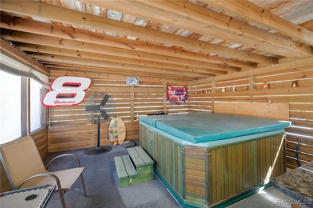 miscellaneous room featuring a jacuzzi and wooden walls