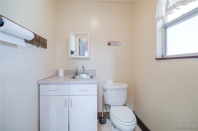 half bath featuring vanity and toilet