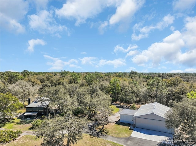 drone / aerial view featuring a view of trees