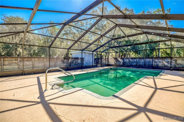 view of swimming pool with glass enclosure, a patio, an outdoor structure, and fence