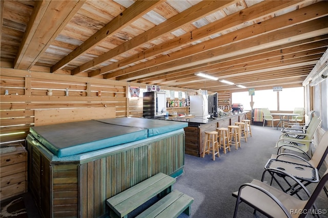 interior space with carpet flooring and a hot tub