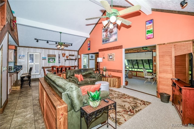 living area featuring high vaulted ceiling, beamed ceiling, tile patterned flooring, and a ceiling fan