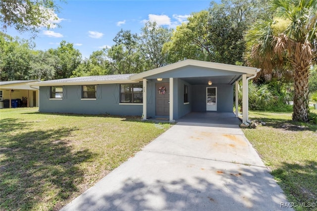 ranch-style house featuring a front lawn and a carport