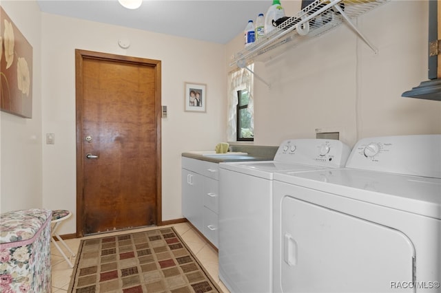 laundry area featuring cabinets, separate washer and dryer, and light tile patterned floors