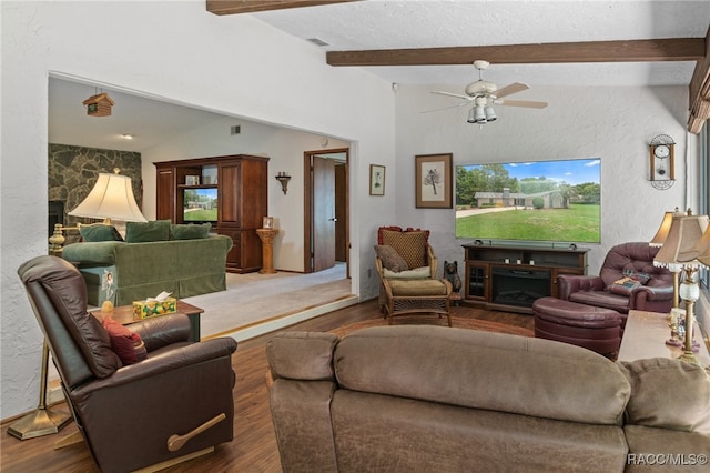 living room with a stone fireplace, ceiling fan, dark hardwood / wood-style flooring, and lofted ceiling with beams