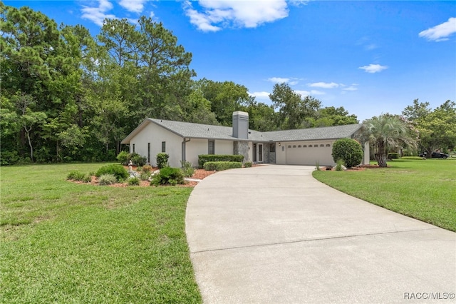 ranch-style home featuring a garage and a front lawn