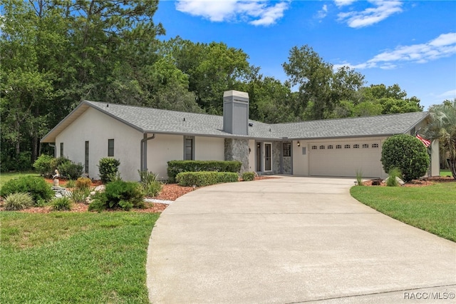 single story home with a garage and a front lawn