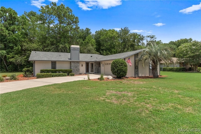 single story home featuring a garage and a front yard