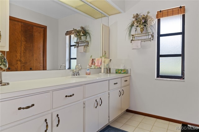 bathroom featuring vanity, tile patterned floors, and plenty of natural light