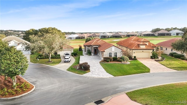 view of front of home with a front yard and a garage