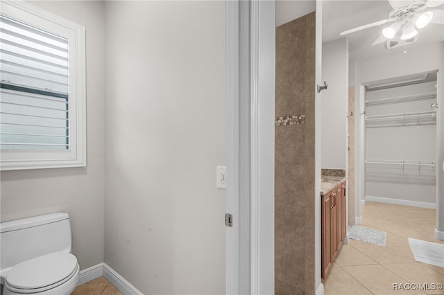 bathroom featuring tile patterned flooring, a wealth of natural light, vanity, and toilet