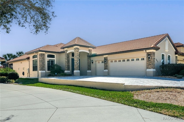 mediterranean / spanish home with a garage