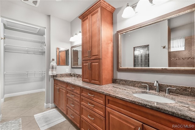 bathroom featuring vanity, tile patterned flooring, and walk in shower