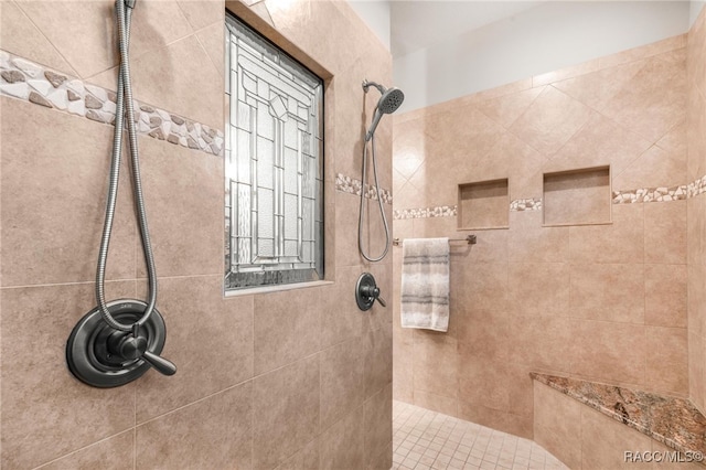 bathroom featuring a tile shower