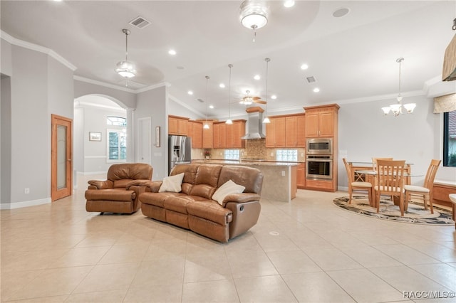 tiled living room featuring ornamental molding, vaulted ceiling, and ceiling fan with notable chandelier