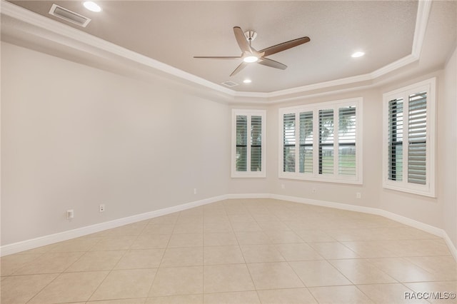 unfurnished room featuring light tile patterned floors, ceiling fan, a tray ceiling, and ornamental molding