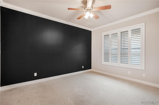 carpeted empty room featuring ornamental molding and ceiling fan